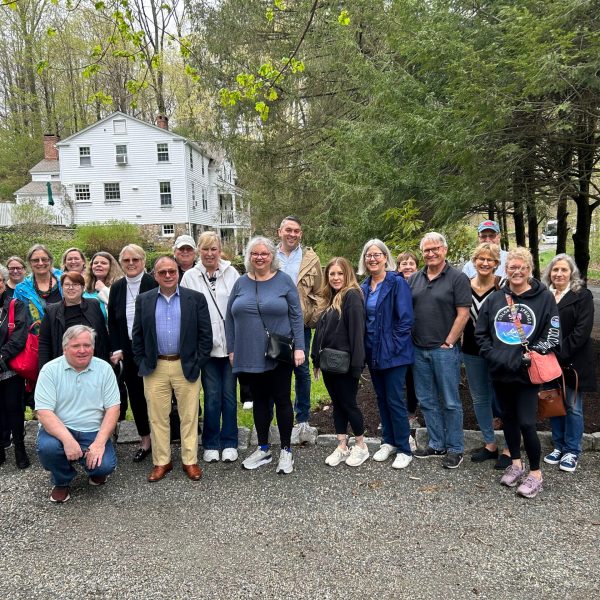 a group of people standing in front of a crowd posing for the camera