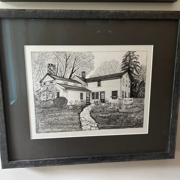 a painting in a frame hanging on a wall