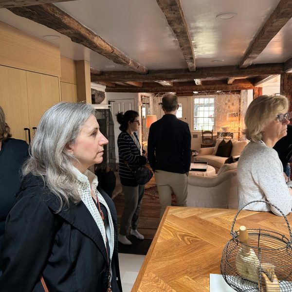 a group of people standing around a table