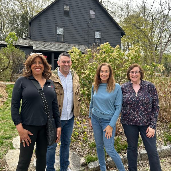 a group of people standing in front of a house