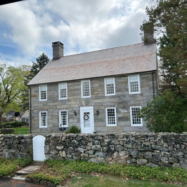 a large stone statue in front of a house