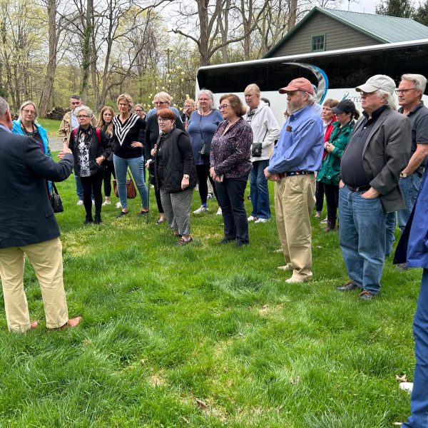 a group of people standing in the grass
