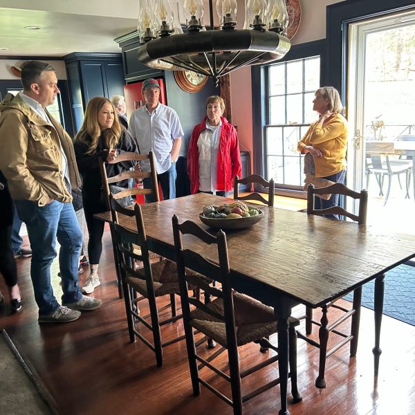 a group of people standing around a table