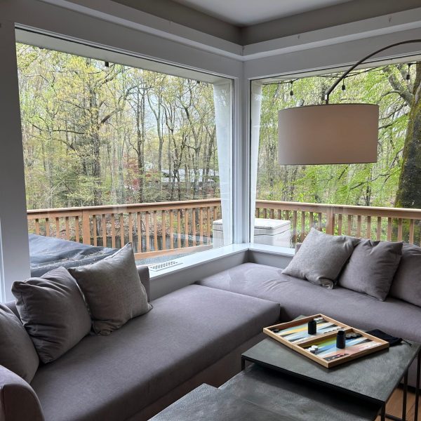 a living room filled with furniture and a large window