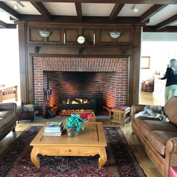 a fireplace in a living room filled with furniture and a fire place