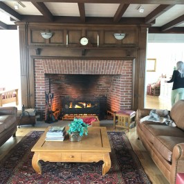 a fireplace in a living room filled with furniture and a fire place