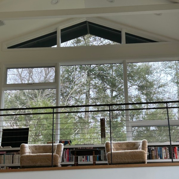 a living room filled with furniture and a large window