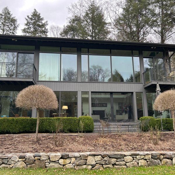 a group of sheep in front of a house