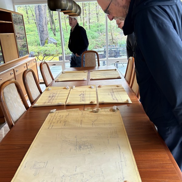 a man sitting on a wooden table