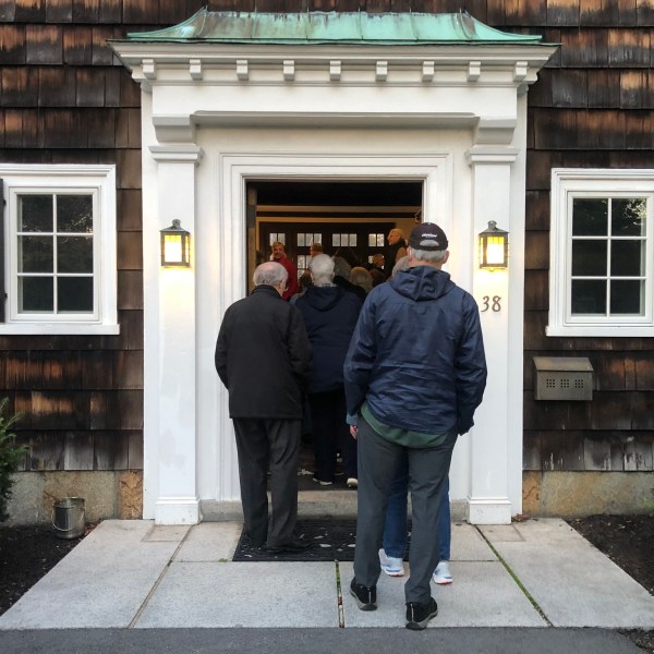 a man and a woman standing in front of a building
