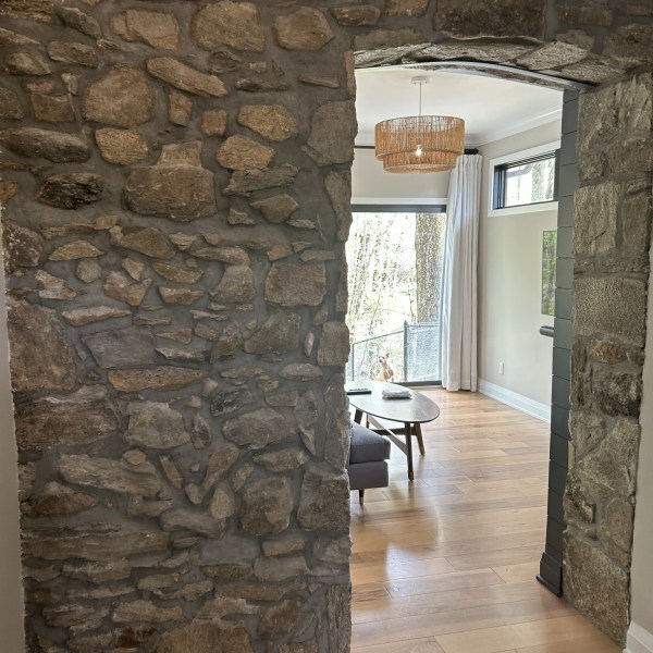 a stone building that has a rock wall