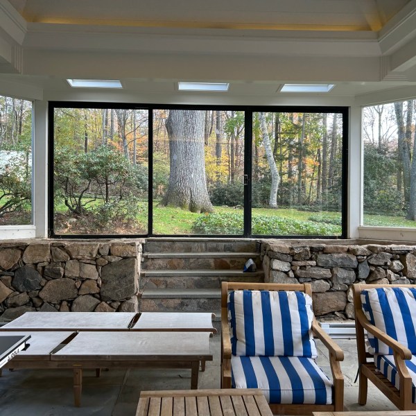 a wooden bench sitting next to a window