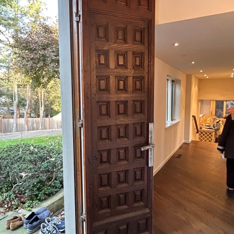 a couple of people that are standing in the door of a building