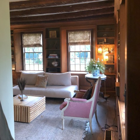 a living room filled with furniture and a large window