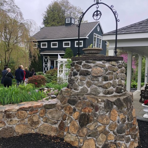 a group of people standing in front of a stone building