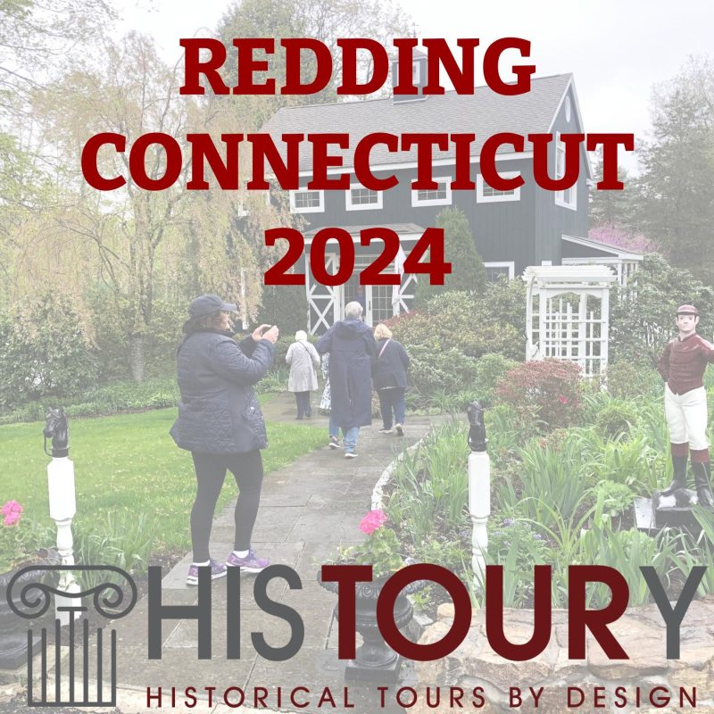 a group of people standing next to a sign