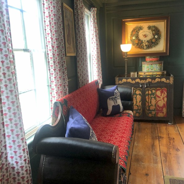 a living room filled with furniture and a clock