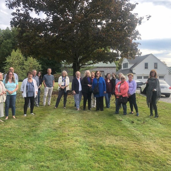 a group of people that are standing in the grass