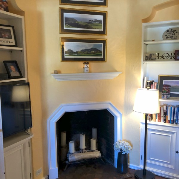 a living room filled with furniture and a fireplace