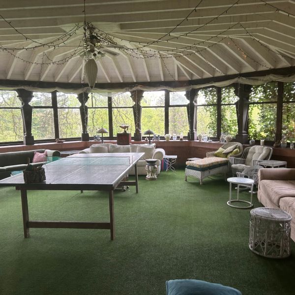 a room filled with furniture and a table in front of a building