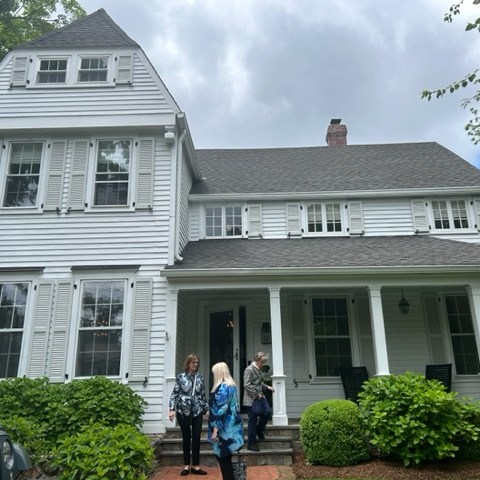 a group of people in front of a house with Edward Gorey House in the background