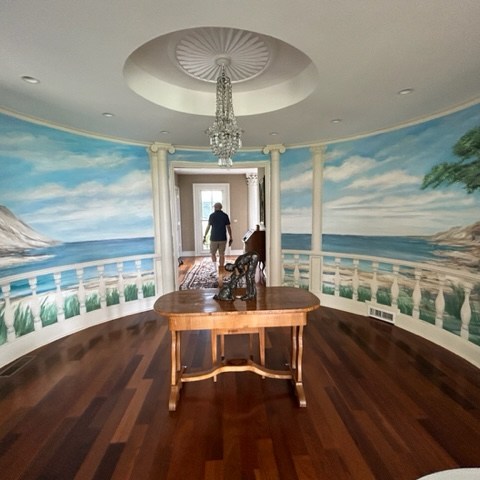 a living room filled with furniture and a large window