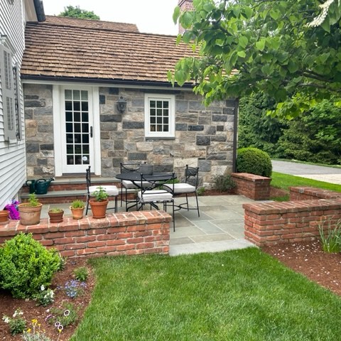 a garden in front of a brick building