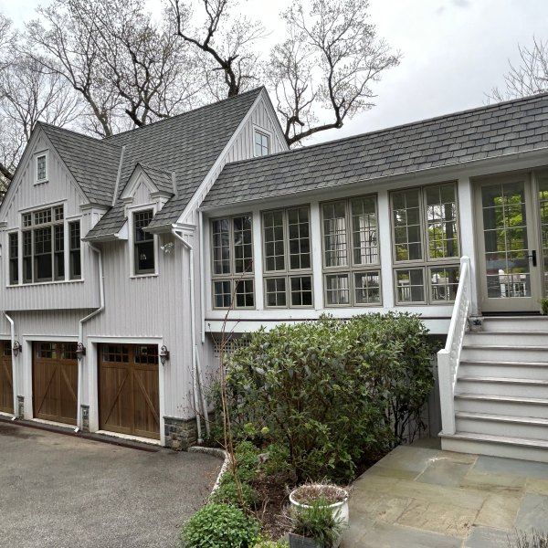 a house with bushes in front of a building