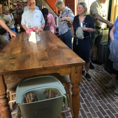 a group of people standing around a table