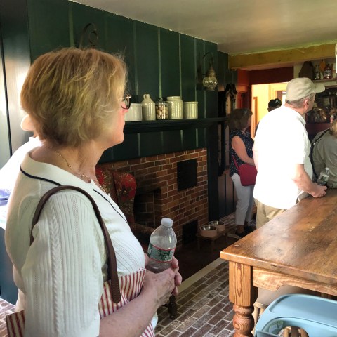 a group of people standing in a kitchen
