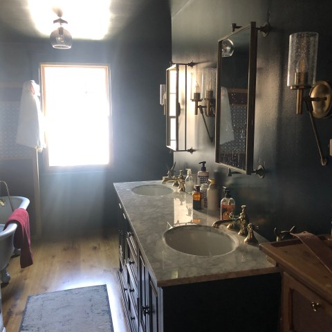 a room with a sink and a mirror