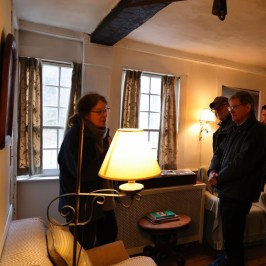 a person sitting at a desk with a laptop in a room