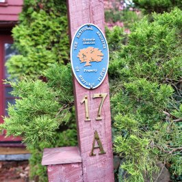 a sign on the side of a garden