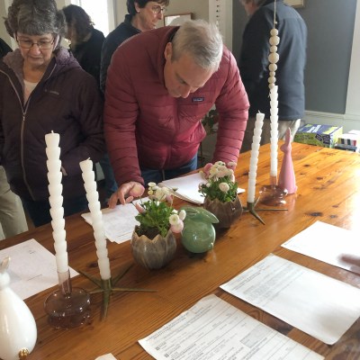 a group of people standing around a table