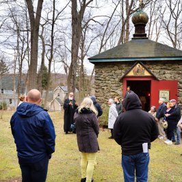 a group of people that are standing in the grass