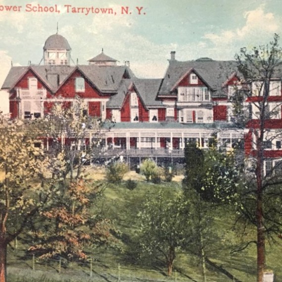 Historic building with red and white facade, lawn, and trees, labeled Hackley Lower School, Tarrytown, N.Y.